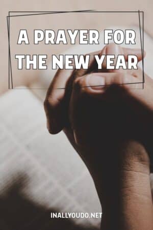 praying hands folded over an open Bible with overlaid text: "A Prayer for the New Year"